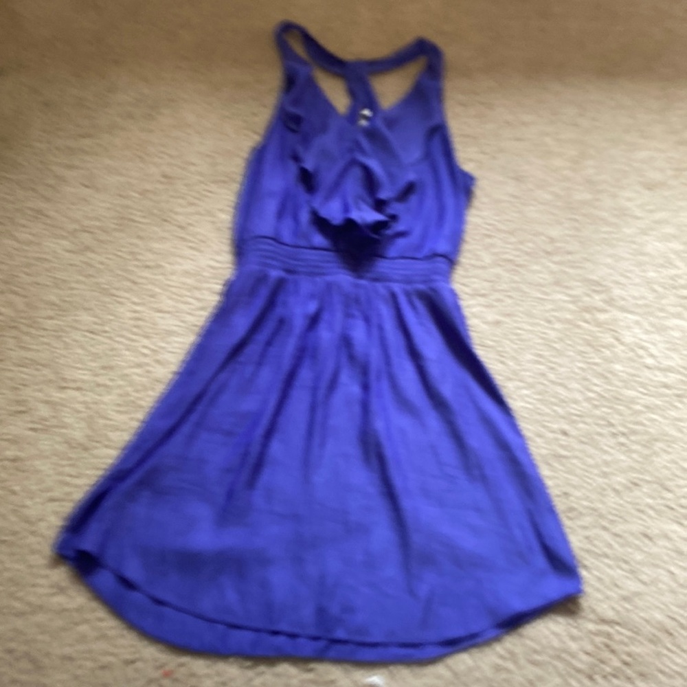 This is a purple dress that has an open back the waist is scrunched up